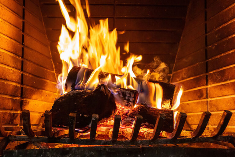 Close up of a fireplace with wood pieces