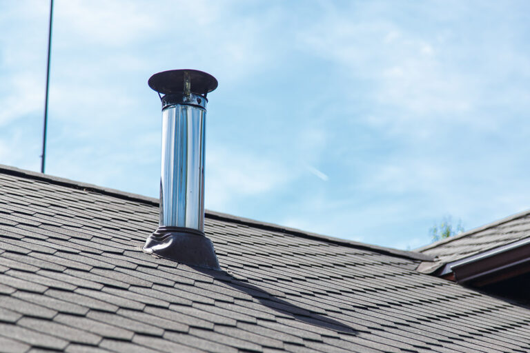 Chimney pipe from stainless steel on the roof of the house