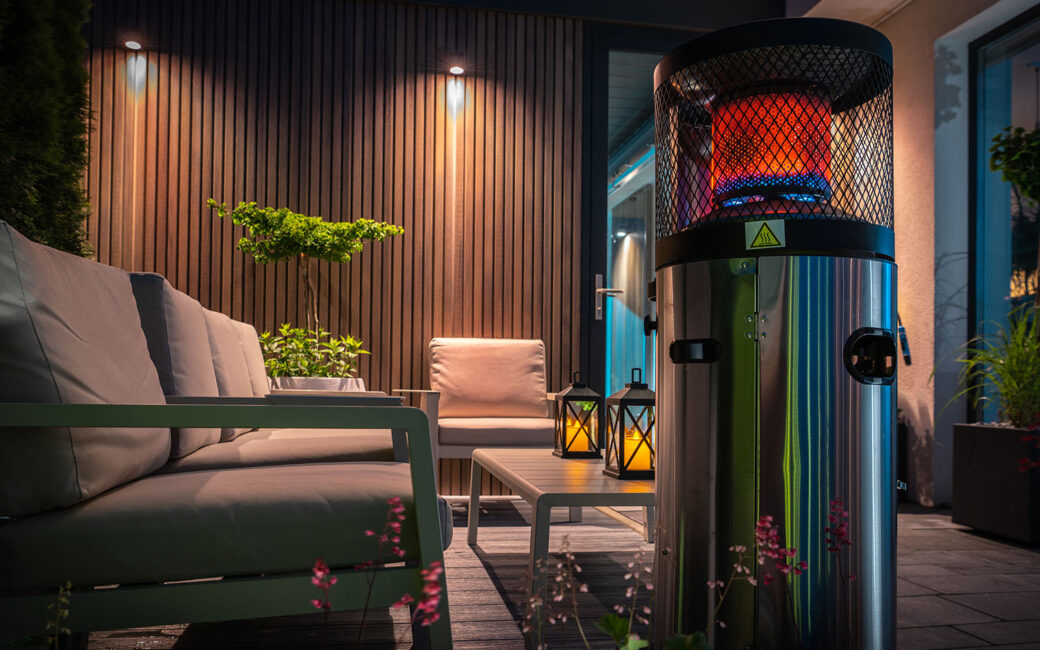 Modern Cozy Patio with Gas Heater Warming the Area During Cold Summer Evening. Residential Backyard Design.