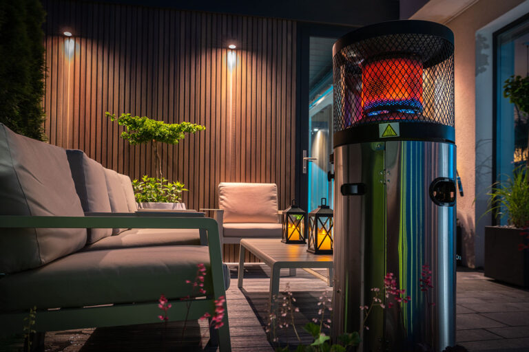 Modern Cozy Patio with Gas Heater Warming the Area During Cold Summer Evening. Residential Backyard Design.