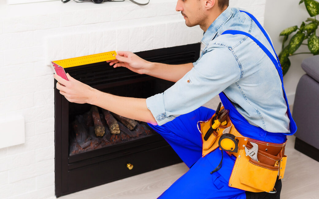 Fireplace installing in white brick wall.