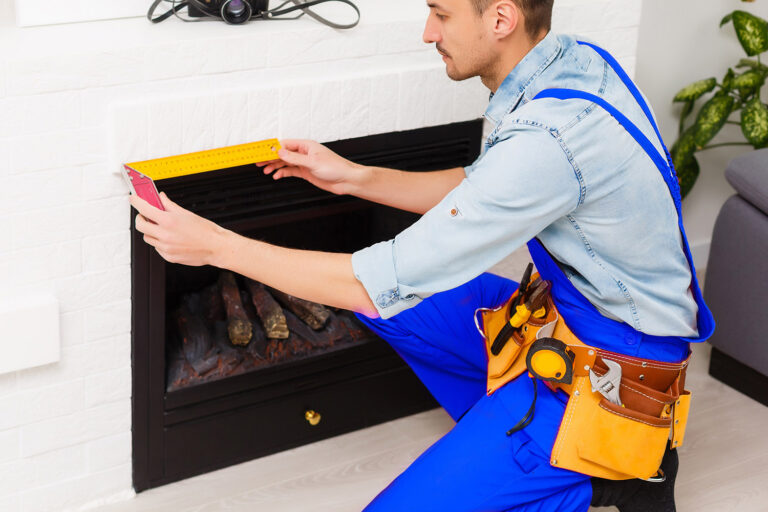 Fireplace installing in white brick wall.