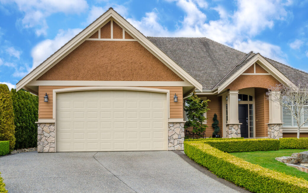 Suburban home with manicured lawn and closed garage door