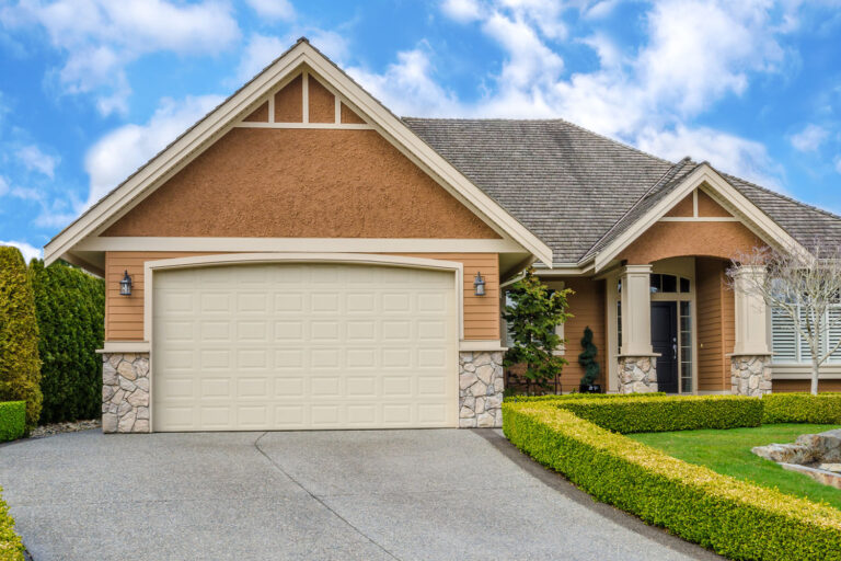 Suburban home with manicured lawn and closed garage door